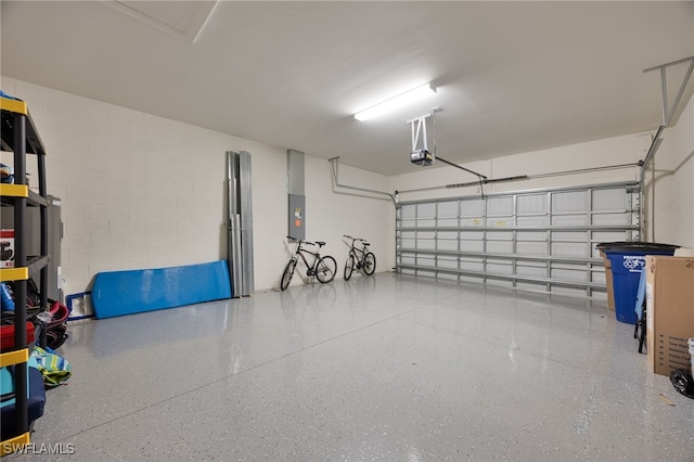 garage with electric panel and a garage door opener