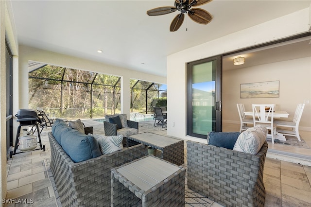 view of patio / terrace featuring outdoor lounge area, glass enclosure, and ceiling fan