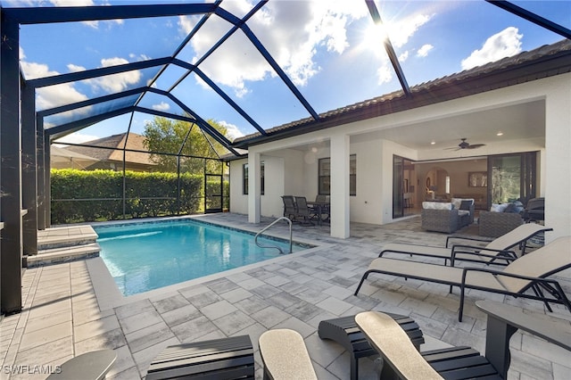 view of swimming pool with outdoor lounge area, ceiling fan, and a patio