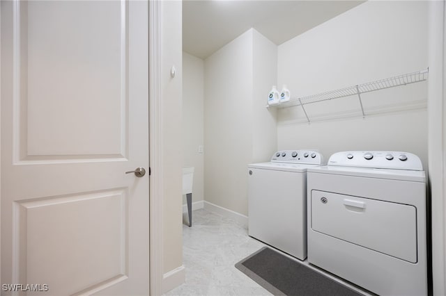 laundry area with washing machine and clothes dryer