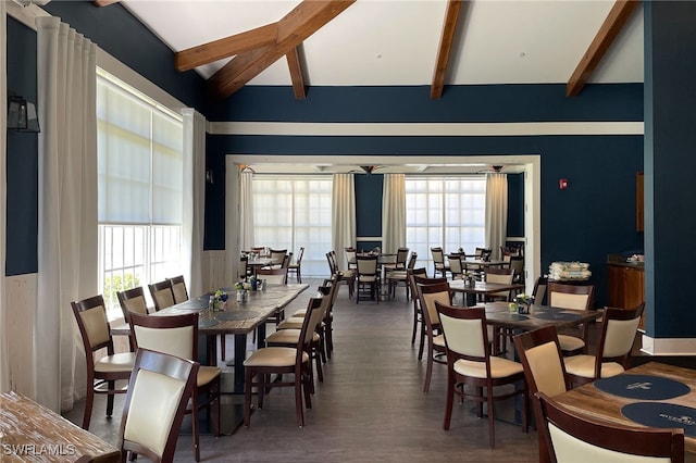 dining area with vaulted ceiling with beams, plenty of natural light, and dark wood-type flooring