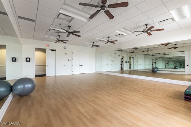 workout area with light hardwood / wood-style flooring