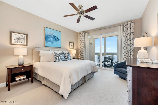 carpeted bedroom featuring access to exterior and ceiling fan