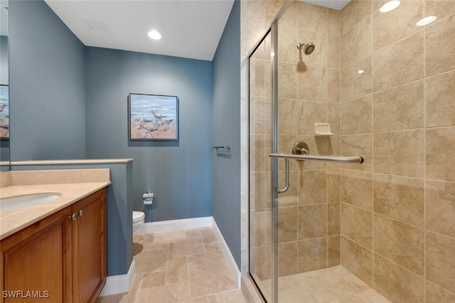 bathroom featuring vanity, toilet, and walk in shower