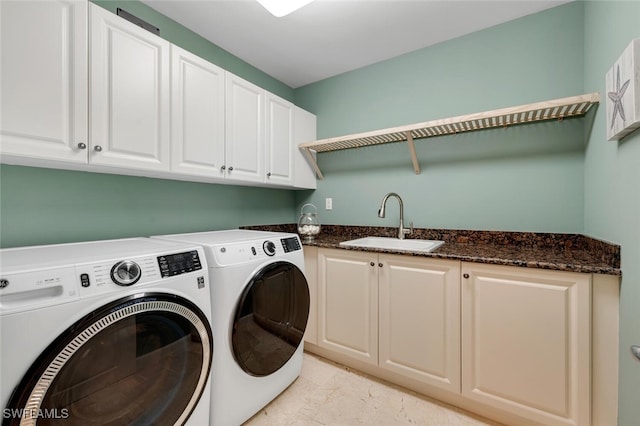 washroom with cabinets, separate washer and dryer, and sink