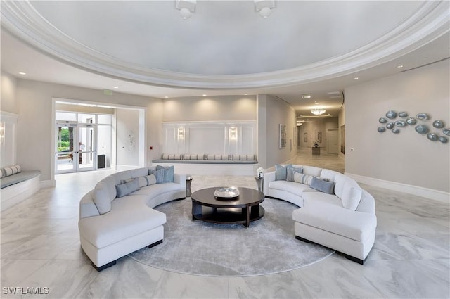 living room featuring ornamental molding, a tray ceiling, and french doors