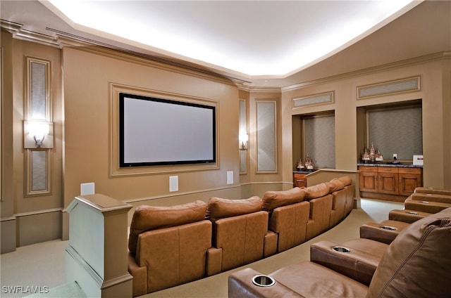 carpeted home theater with ornamental molding