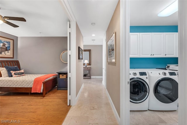 washroom with ceiling fan, cabinets, and washer and dryer