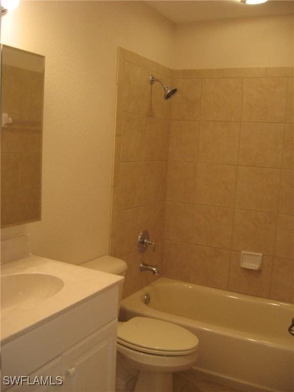 full bathroom with vanity, toilet, and tiled shower / bath