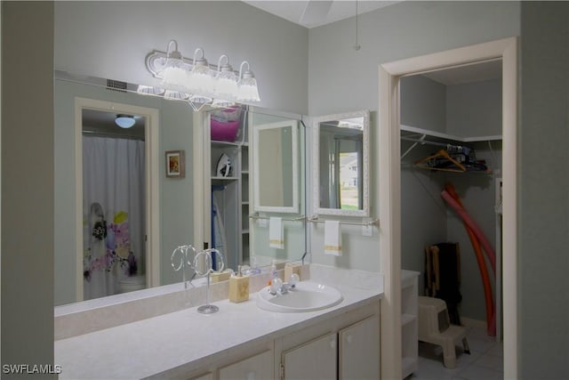 bathroom with tile patterned floors, vanity, and toilet