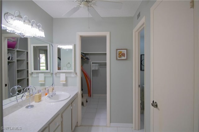 bathroom with a textured ceiling, vanity, tile patterned floors, and ceiling fan