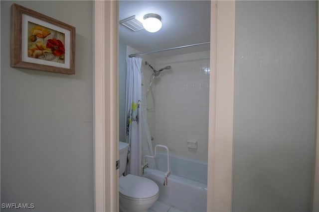 bathroom with tile patterned floors, toilet, and shower / bath combo with shower curtain