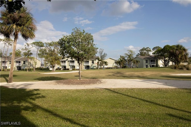 view of home's community with a yard