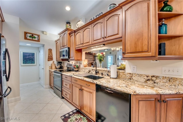 kitchen with appliances with stainless steel finishes, light tile patterned floors, light stone counters, and sink