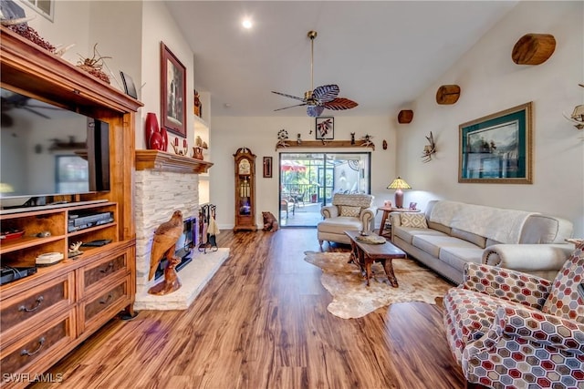 living room with a fireplace, hardwood / wood-style floors, and ceiling fan