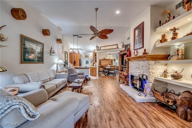 living room with ceiling fan, lofted ceiling, and light hardwood / wood-style flooring