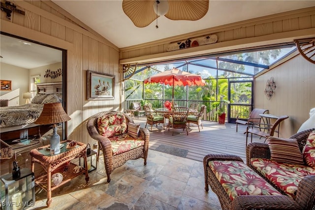 sunroom featuring ceiling fan and vaulted ceiling