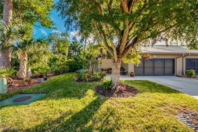 view of front of property with a front yard and a garage