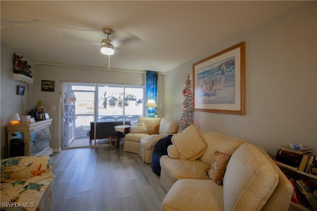 living room featuring light hardwood / wood-style flooring and ceiling fan