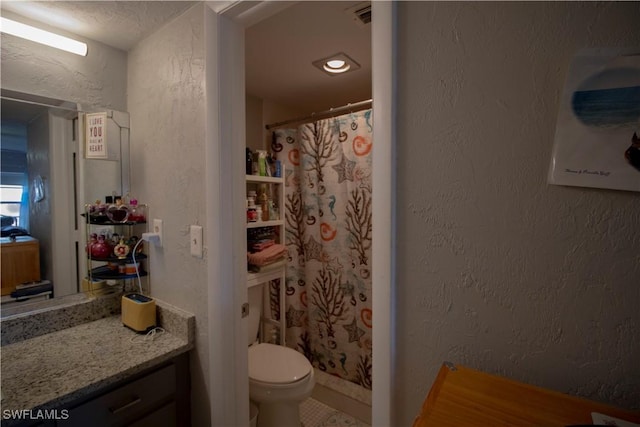 bathroom with vanity, a shower with shower curtain, a textured ceiling, and toilet