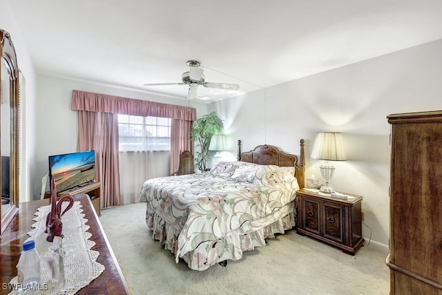 bedroom with ceiling fan and light carpet