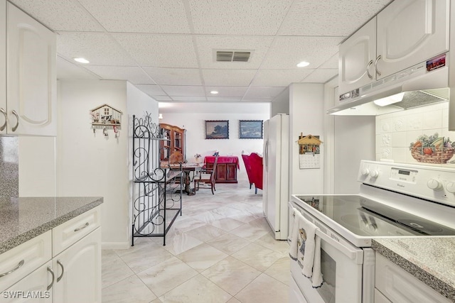 kitchen featuring white cabinets, white appliances, and a paneled ceiling