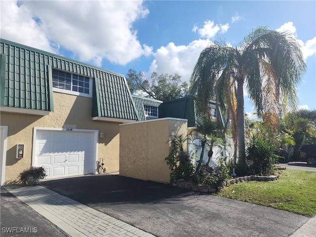 view of property exterior featuring a garage