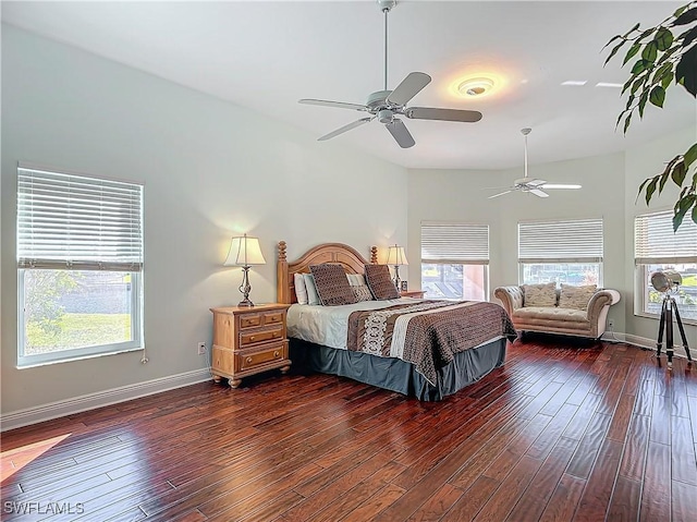 bedroom featuring multiple windows, ceiling fan, and dark hardwood / wood-style floors