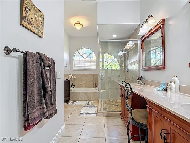 bathroom with tile patterned floors, vanity, and independent shower and bath