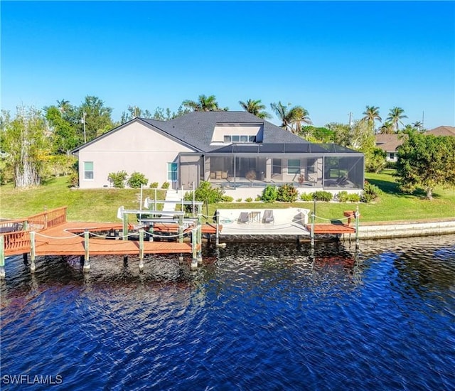 back of property featuring a lawn, glass enclosure, and a water view