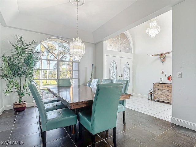 dining space with french doors, an inviting chandelier, and dark tile patterned floors