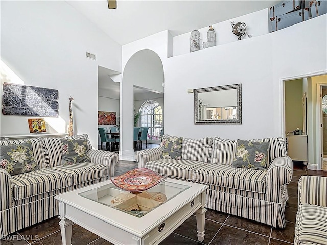 living room featuring ceiling fan and high vaulted ceiling