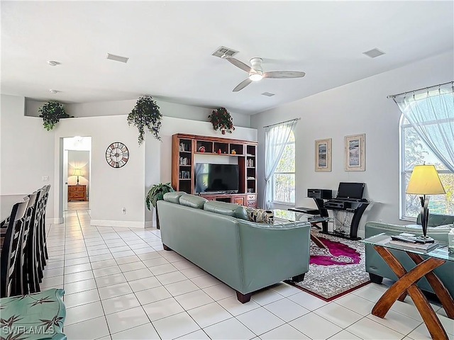 tiled living room featuring ceiling fan and plenty of natural light