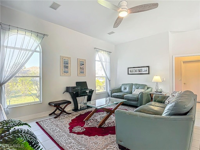 tiled living room with ceiling fan and a healthy amount of sunlight