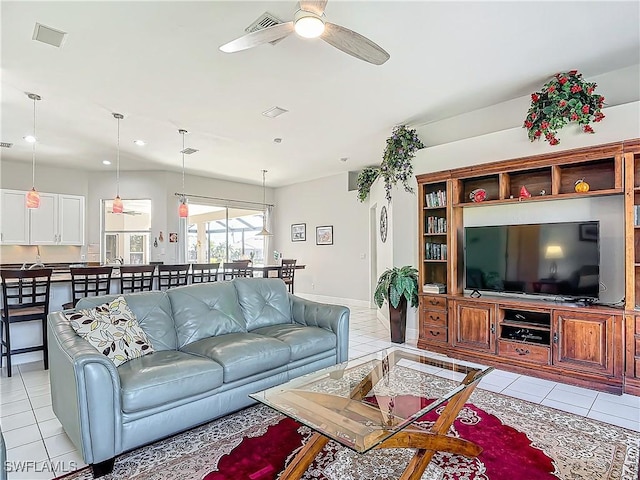 tiled living room with ceiling fan