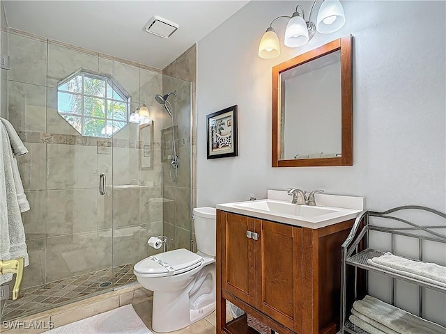 bathroom featuring vanity, an enclosed shower, and toilet