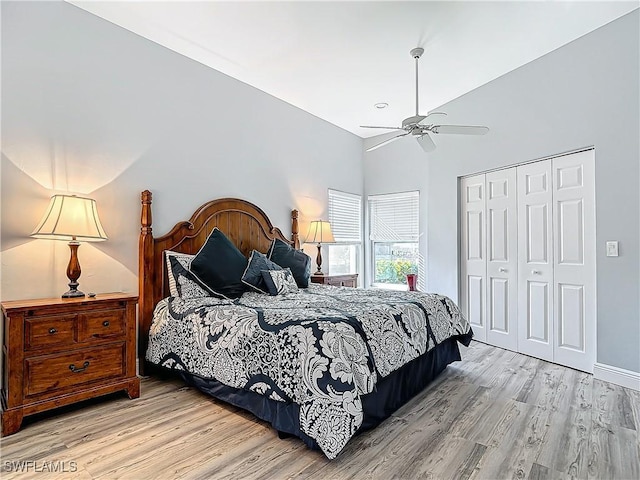 bedroom with ceiling fan, light wood-type flooring, and a closet