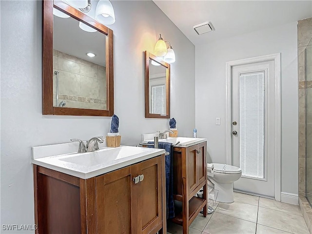 bathroom with tile patterned floors, a shower, vanity, and toilet