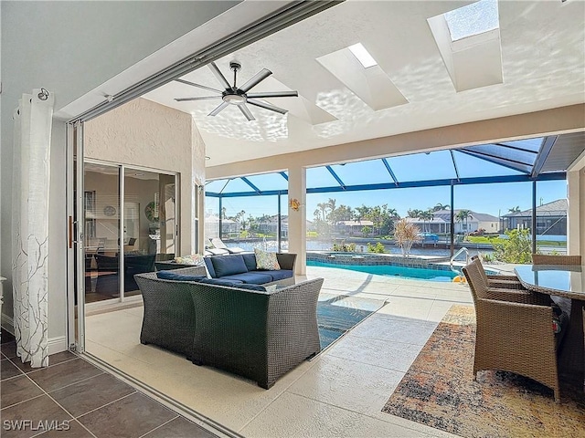 interior space featuring glass enclosure, ceiling fan, and an outdoor living space