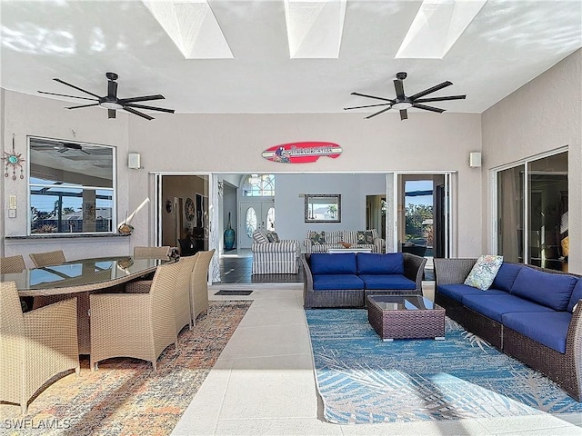 living room featuring tile patterned floors and a skylight