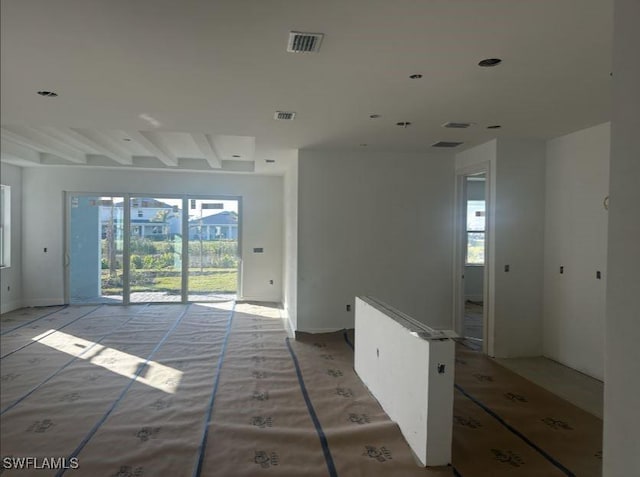 unfurnished room featuring beamed ceiling