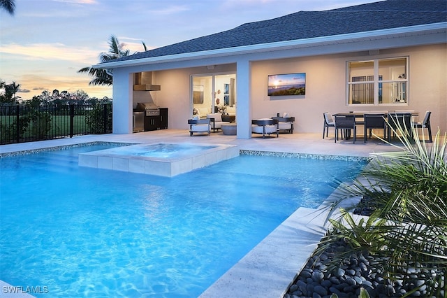 pool at dusk featuring a fenced in pool, fence, exterior kitchen, and a patio