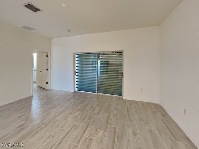 empty room with light hardwood / wood-style flooring