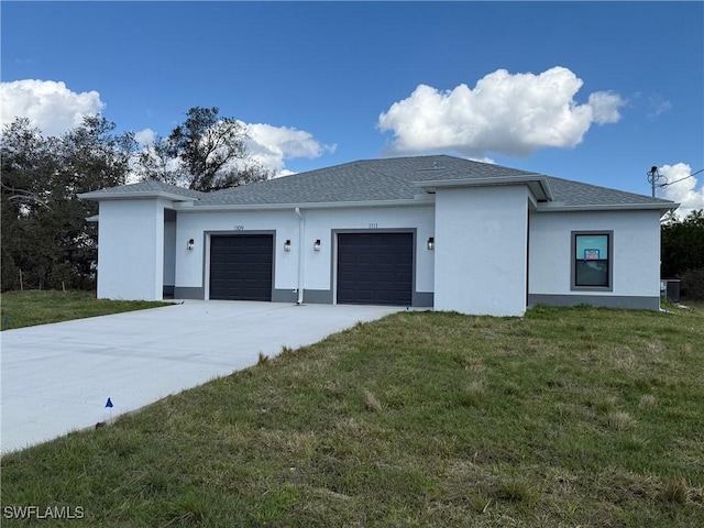 view of front of home featuring a garage, a front yard, and central air condition unit