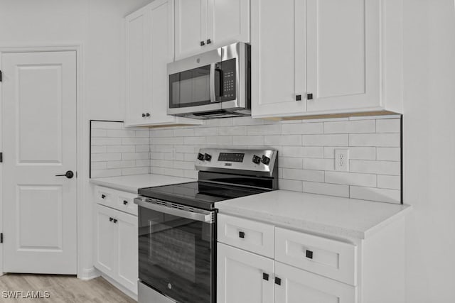 kitchen featuring stainless steel appliances and white cabinets