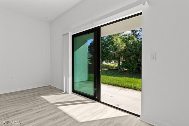 entryway with baseboards and wood finished floors