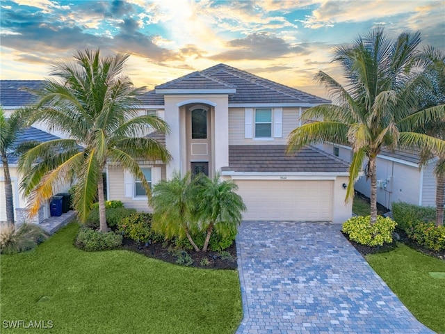 view of front of home featuring a lawn and a garage