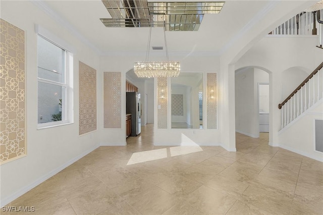 interior space with a notable chandelier and crown molding