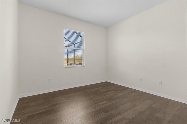 unfurnished room featuring dark wood-type flooring