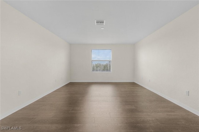 empty room featuring dark wood-type flooring